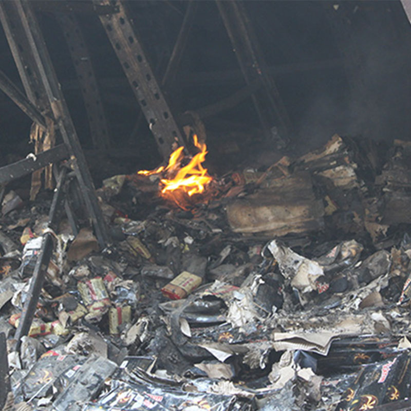 Fire reigniting in warehouse building days after initial fire fighting efforts